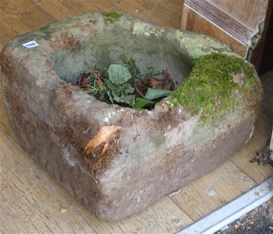 A circular stone trough